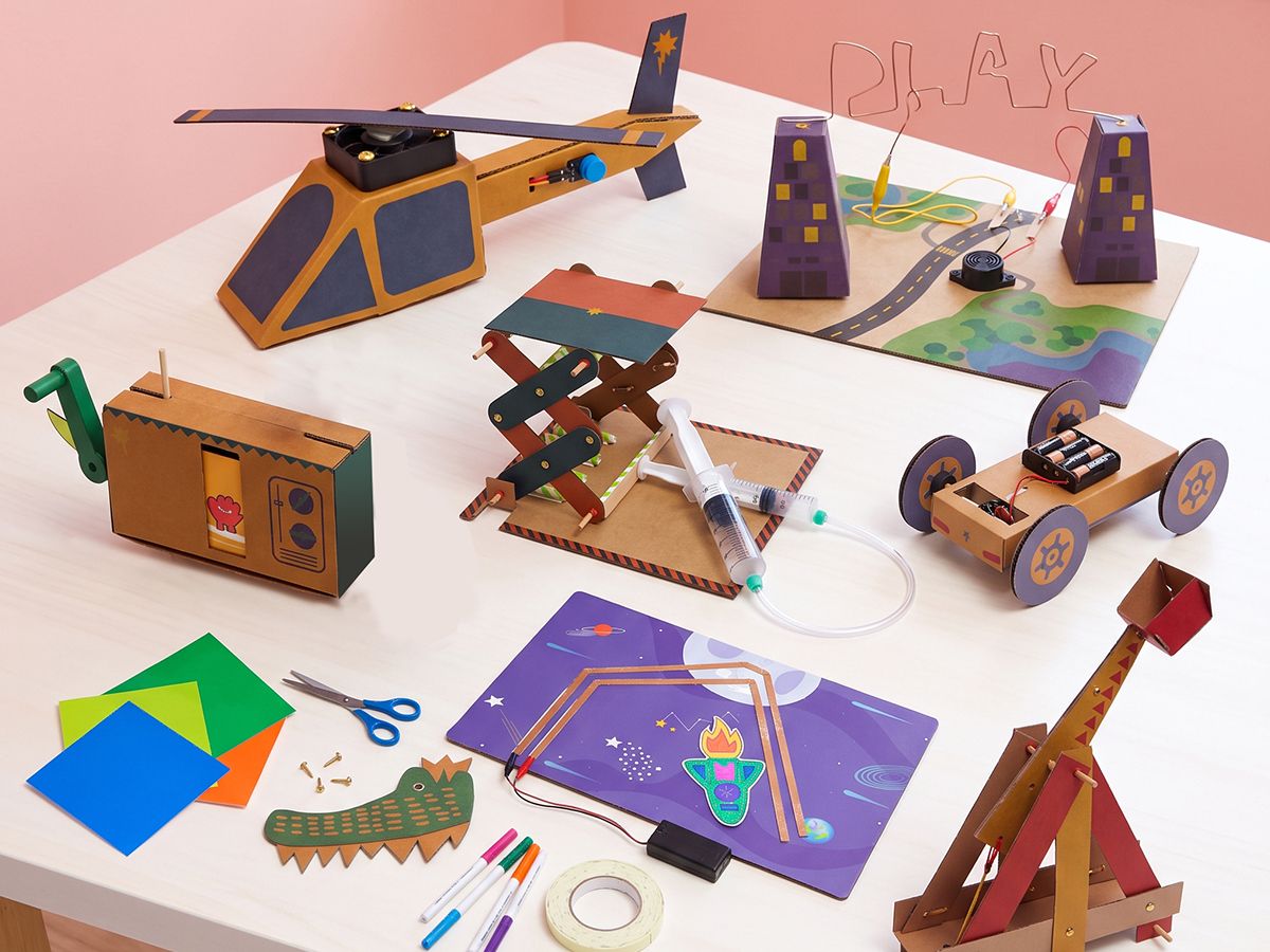 a table of finished Origins projects from all four levels, bright, top-down, colourful