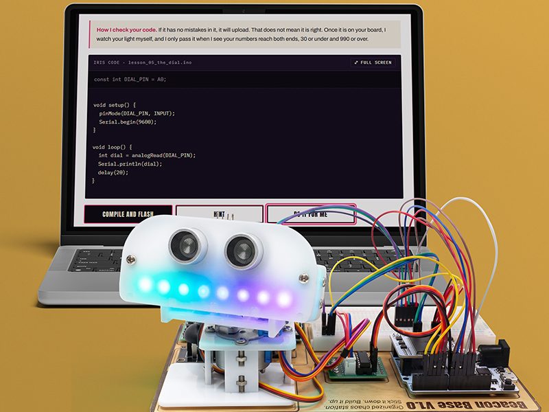 IRIS's code on a laptop behind the finished Beacon robot, lit up